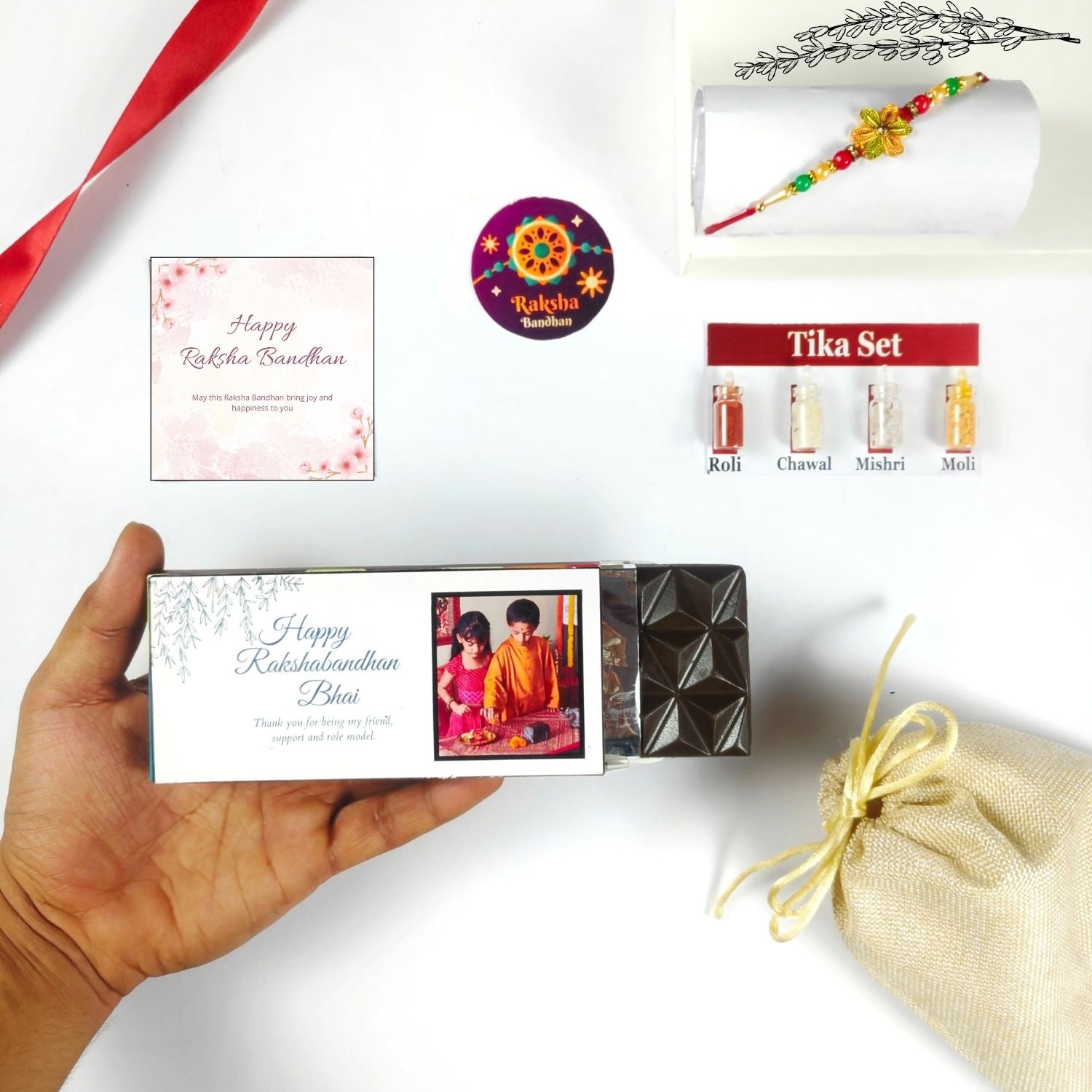 Personalized Rakhi Hamper For Brother, Rakhi Chocolate Gift For Bhai With 35G Chocolate Bar, Rakhi, Tika Set, Greeting Card And Potli | Unique Raksha Bandhan Gift